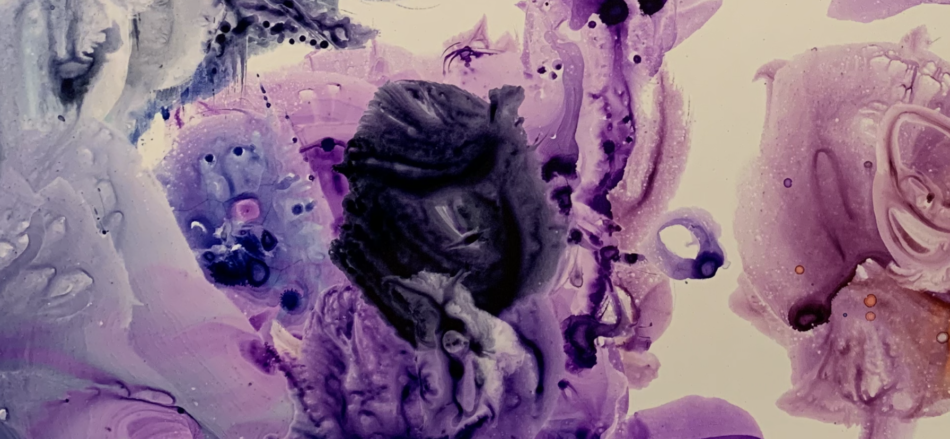 Leftover shades of purple at the bottom of a watercolor painting palette.